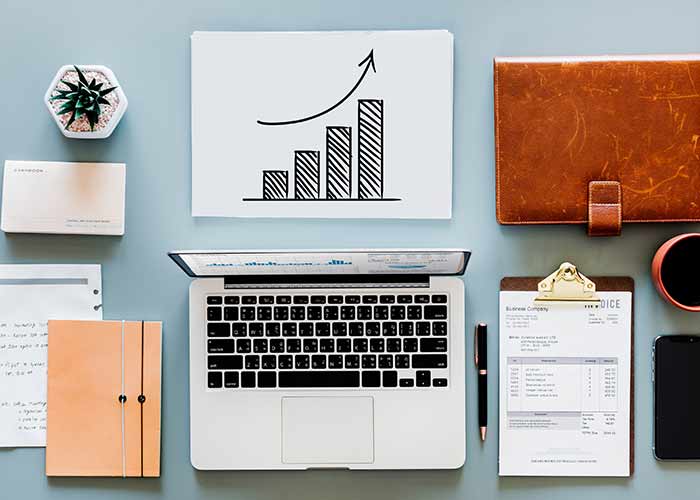 flatlay of charts laptops and other stationery